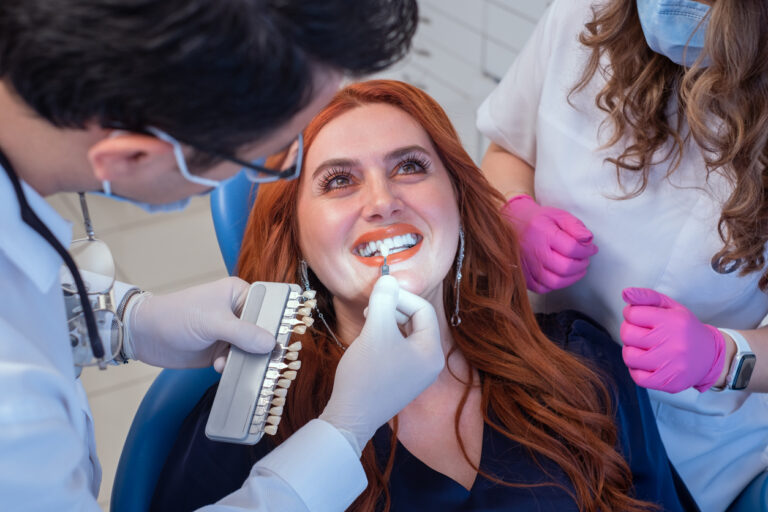 Doctors using color samples to show a patient her options for her dental veneers.
